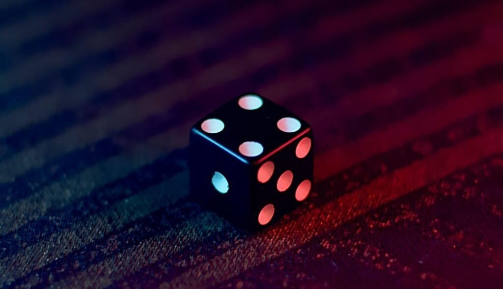 white and black dice on red textile
