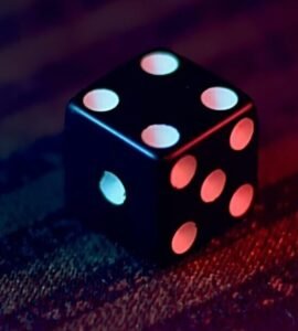 white and black dice on red textile